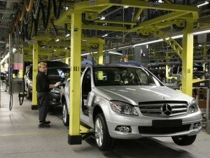 A worker of the Mercedes-Benz car factory in Bremen in northern Germany, checks a C Class car at the assembly line