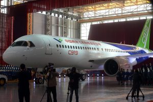 epa05007034 Workers roll out the first C919 passenger jet plane at the state-owned Commercial Aircraft Corporation of China Ltd (COMAC) in Shanghai, China02 November 2015. China has spent seven years and huge amount to develop the 158-seat jet to boost its aviation industry, posing a challenge to Airbus and Boeing. EPA/STRINGER CHINA OUT